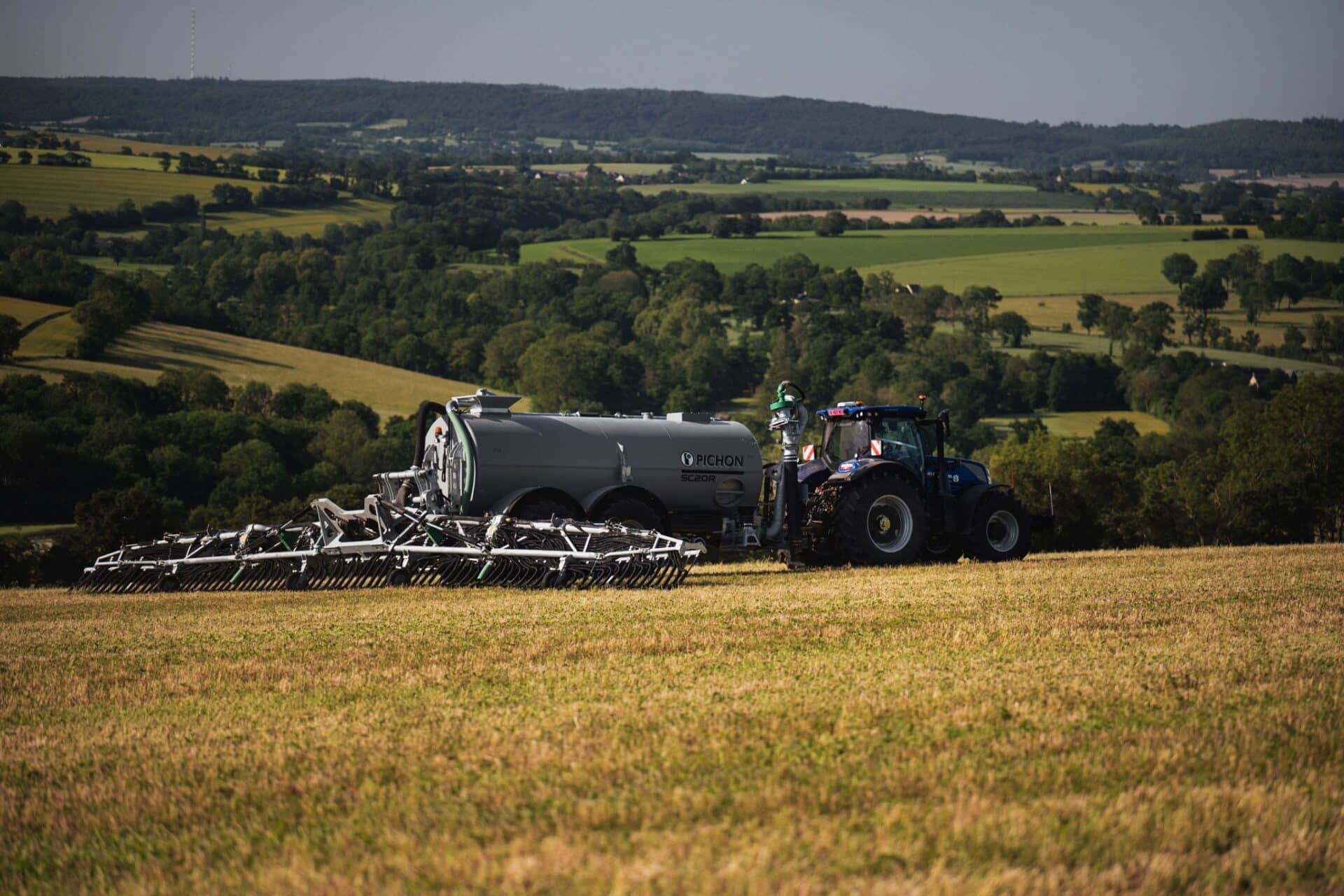 Pichon SC20R slurry tanker with a trailing-shoe applicator behind a tractor in rolling farmland
